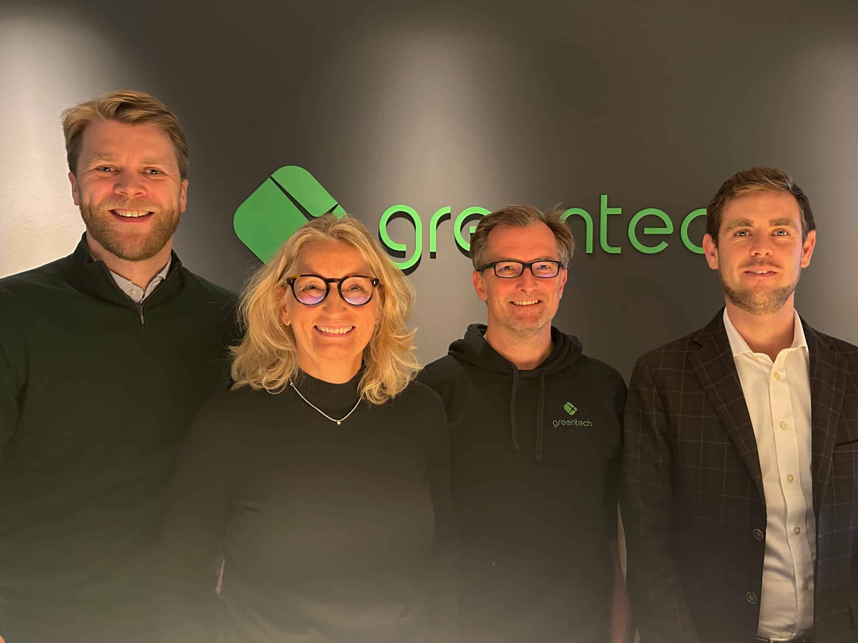 picture of greentech team in front of logo